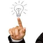 Business man hand drawing light bulb isolated on white