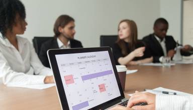 Woman planning work or making events schedule with planner calendar