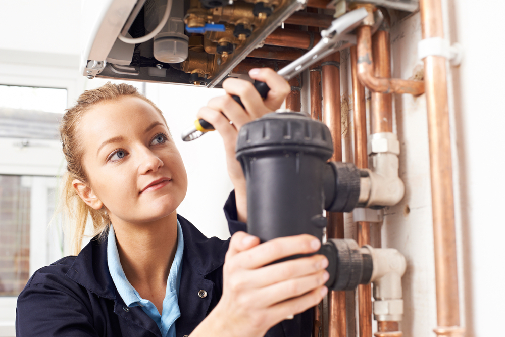 Female,Plumber,Working,On,Central,Heating,Boiler