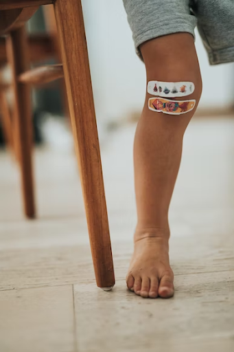Decorated band aid on kid’s leg